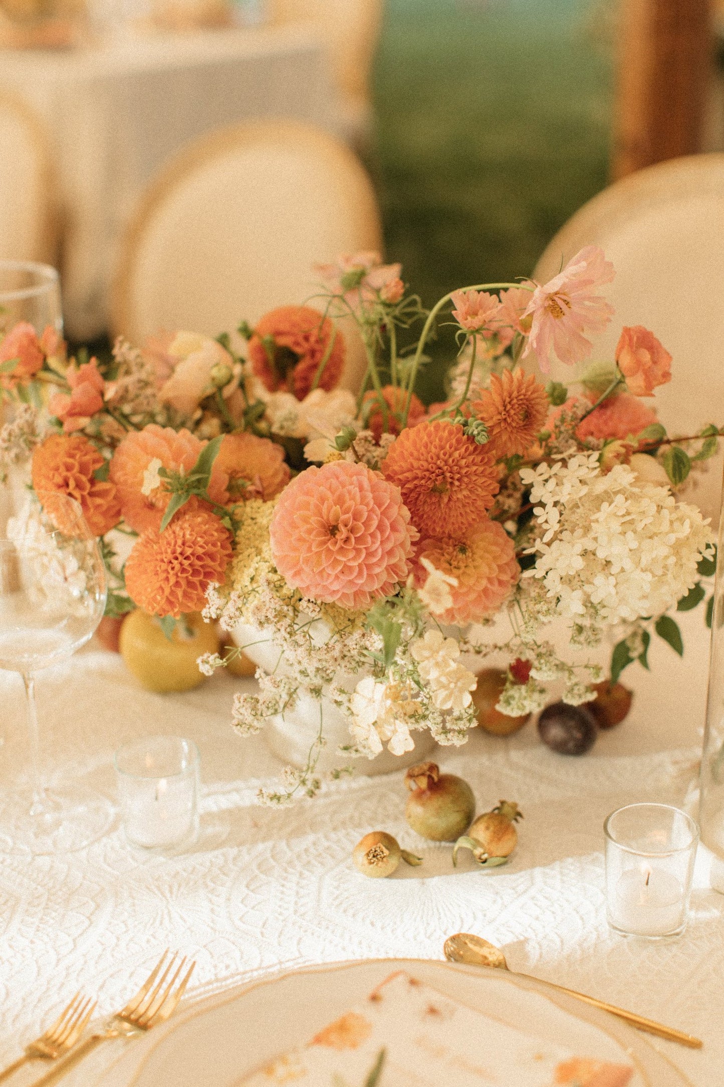 centerpiece with dahlias and hydrangeas on a wedding dinner table